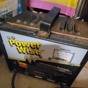 Power Wise Charger front view for golf cart batteries Close-up of Power Wise Charger LED status lights 36V and 48V Power Wise Charger plug compatibility Golf cart with connected Power Wise smart charger Weather-resistant Power Wise Charger with cooling vents